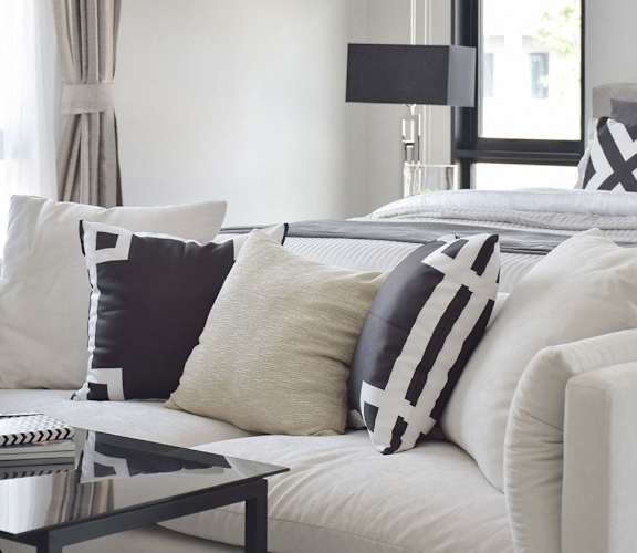 White couch with decorative pillows