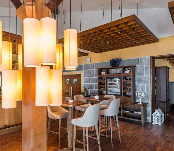 a dining room with a table and chairs and a bar at The Georgian Apartments, Missouri