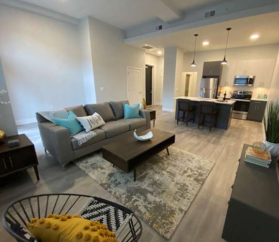 a living room with a couch and a table at The Georgian Apartments, St Louis, MO, 63104