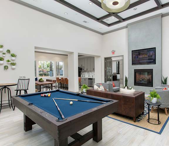 a clubhouse with a pool table and a living room at The Grove, Ontario, CA