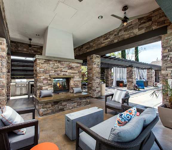 a patio with furniture and a fireplace at The Grove, Ontario, CA