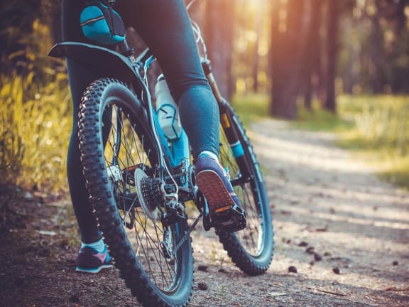 a person riding a bike on a trail