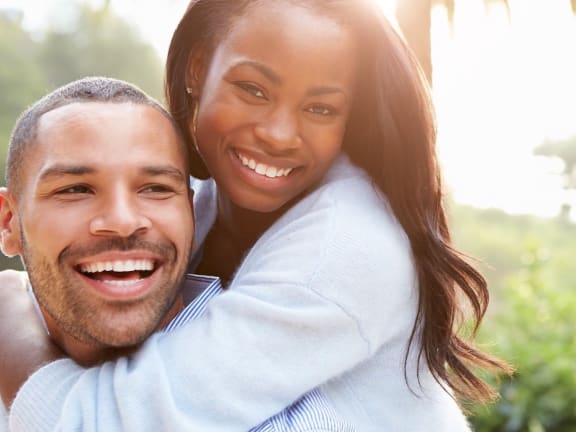 a young African American man and woman with smiles on their faces