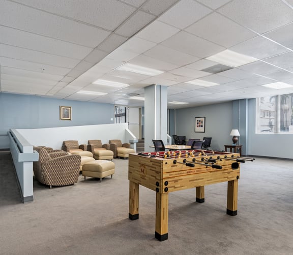 Community room with seating and foosball table, Chancellor Hotel Apartments