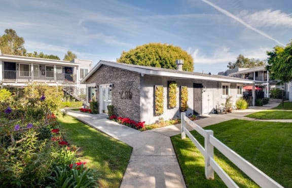a house with a garden and a white fence