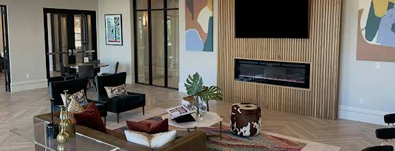 a living room with a fireplace and a tv on the wall