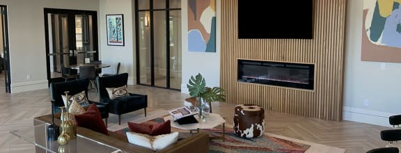 a living room with a fireplace and a tv on the wall