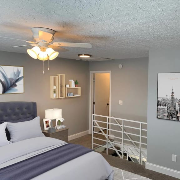 a bedroom with a bed and a ceiling fan