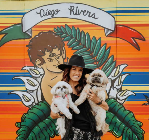 A woman holding two dogs at The Rey Downtown, Phoenix, 85003