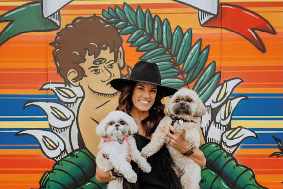 A Woman Holding Two Dogs at The Rey Downtown Apartments, Phoenix, Arizona