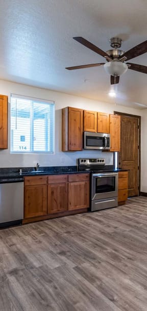 a kitchen with a stove top oven next to a refrigerator