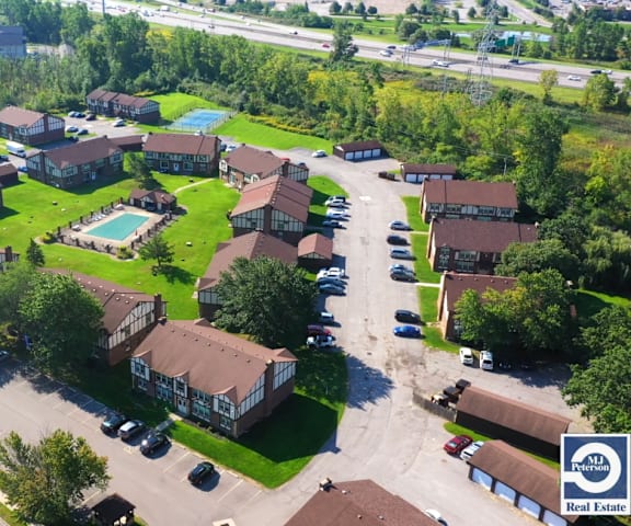 an aerial view of a neighborhood with houses and a pool