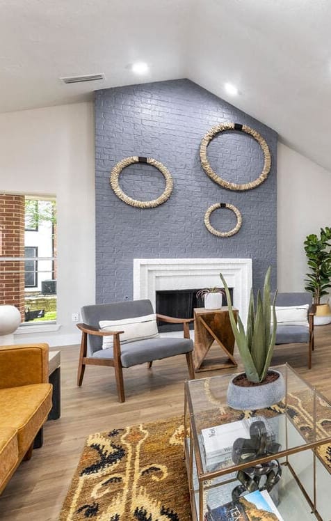an open living room with a kitchen and a fireplace