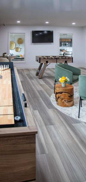 A living room with a pool table and a tv.