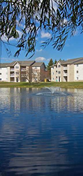 A building is reflected in the water in front of it.