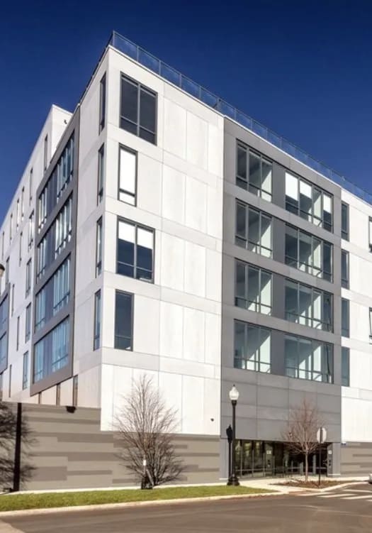 a large white building with cars parked in front of it