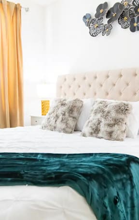 a bedroom with a large bed and a green blanket