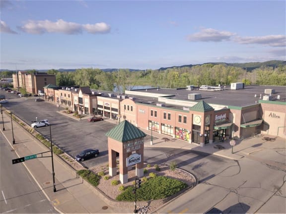 an aerial view of a city street with buildings and a parking lot