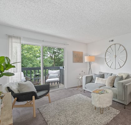 a living room with a couch and a clock on the wall