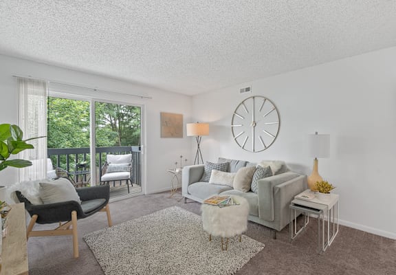 a living room with a couch and a clock on the wall