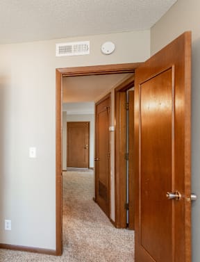 the view of a bedroom with a closet and a mirrored closet door