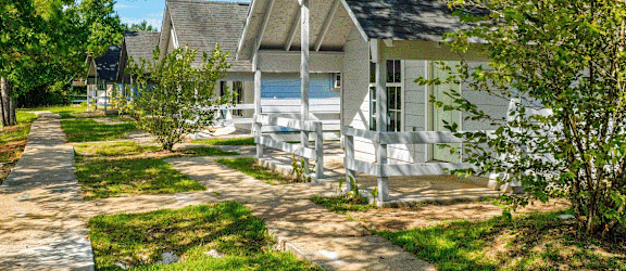 a row of white cottages on a sunny day