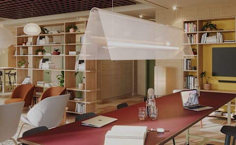 A modern conference room with a long table and chairs.