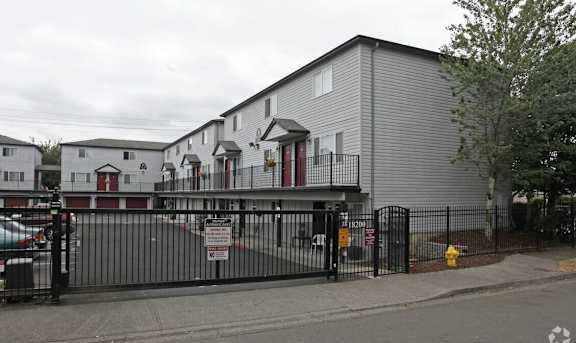 A grey building with a black fence in front of it.