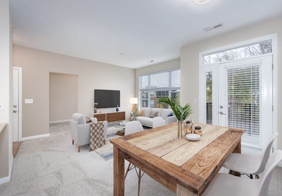 a living room with a wooden table    and a television
