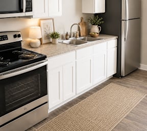 a kitchen with stainless steel appliances and white cabinets at Trails Corner Apartments, Raleigh, NC, 27610