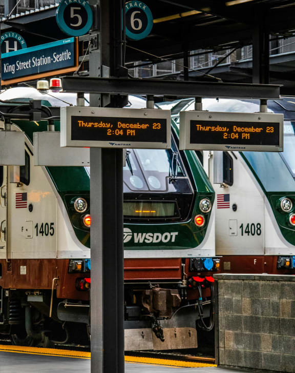 a green and white train at a train station