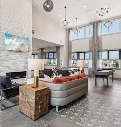 a living room with couches and chairs and a fireplace at The Virginia, Seguin, Texas