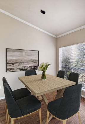 a dining room with a table and chairs and a balcony at Madison at the Arboretum, Texas