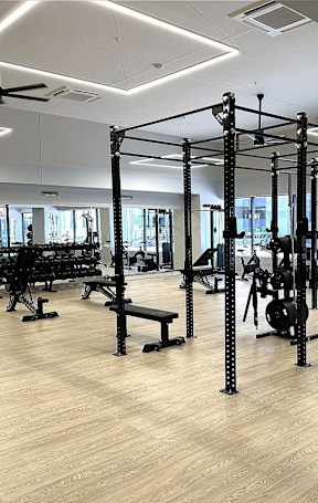 A gym with a variety of equipment including a squat rack  at 7 West 7th Apartments, Cincinnati