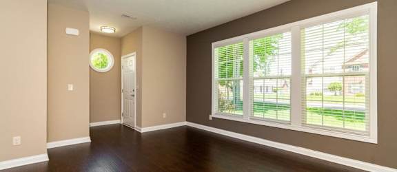 A room with brown walls and a wooden floor.