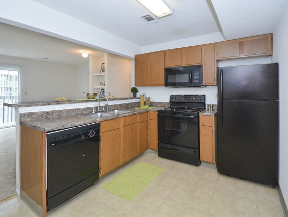 Kitchen with Black Appliances with Tile Style Flooring