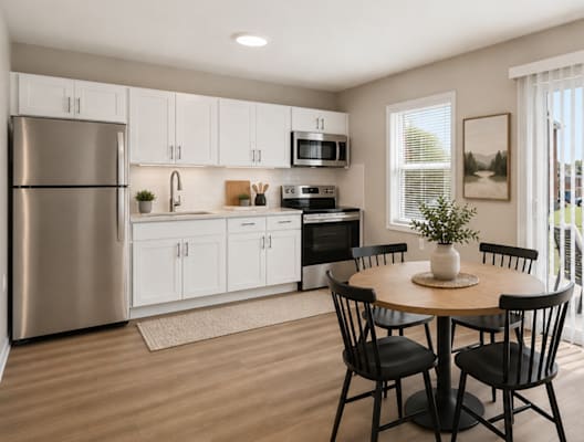 A modern kitchen with a dining table set for two.
