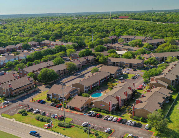 an aerial view of a neighborhood with houses and a parking lot  at The Woodlands, Fort Worth, 76120