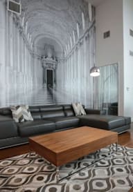 A living room with a grey couch and a wooden coffee table.