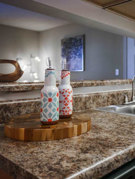A kitchen with wooden cabinets and a granite counter top.