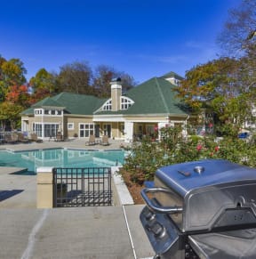a swimming pool with a house in the background