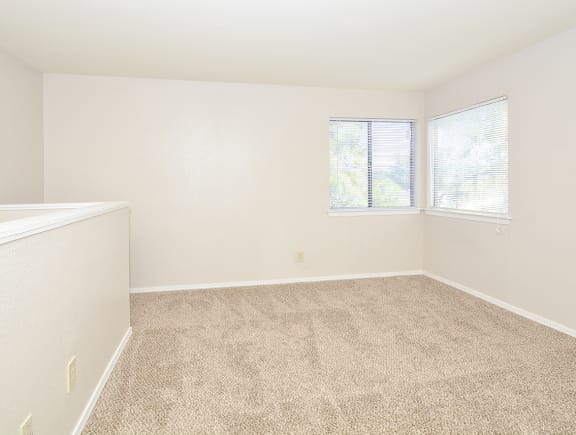 Spacious Carpeted Bedroom with Double Windows