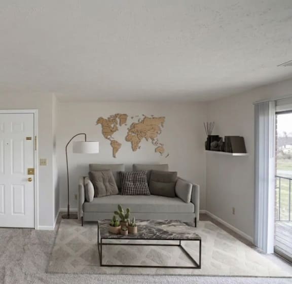 A living room with a grey sofa and a wooden coffee table.