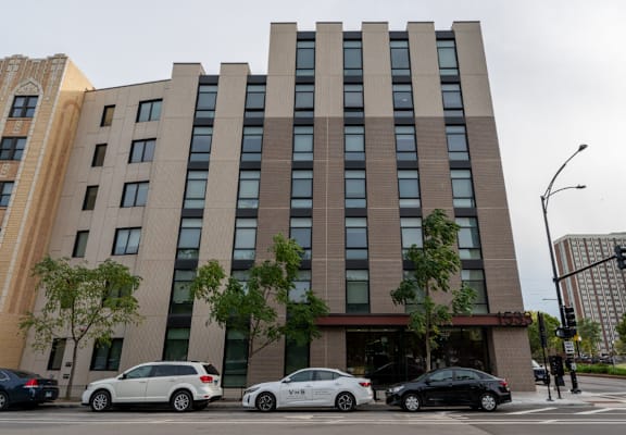 A modern building with a parking lot in front of it.