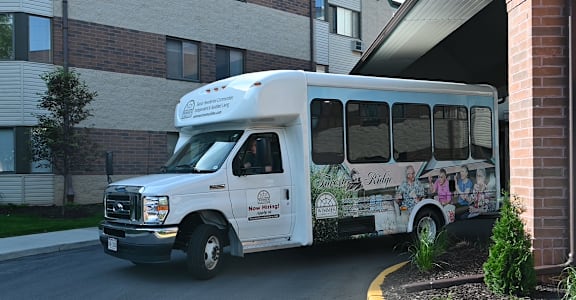 a white bus parked in front of a building