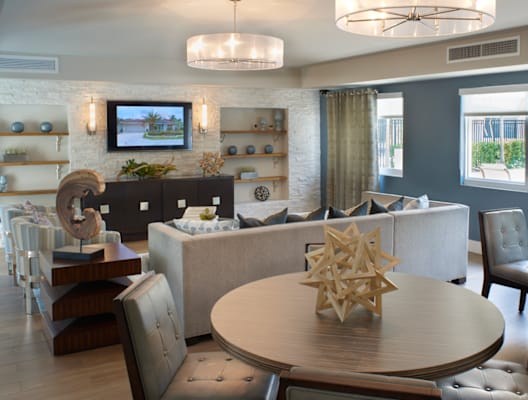 a living room and dining room with a table and chairs