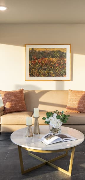a living room with a couch and a table with a book
