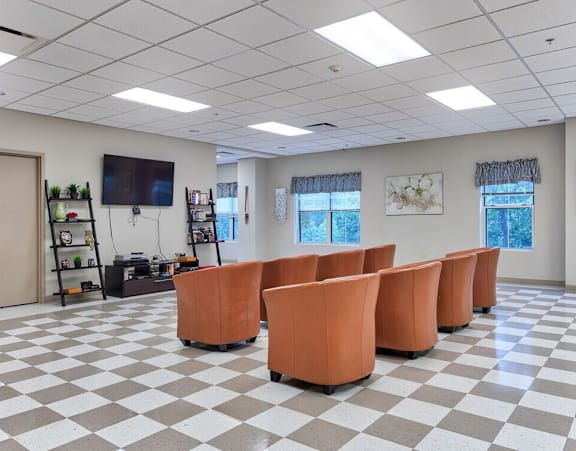 an empty conference room with chairs and a tv