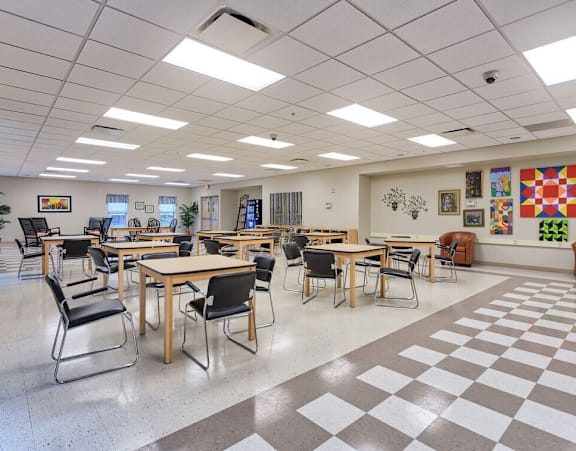 a dining room with tables and chairs and a checkered floor