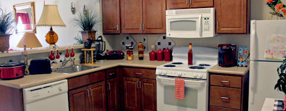 a kitchen with white appliances and wooden cabinets